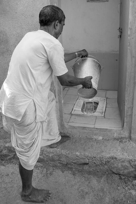 A pit latrine being flushed after use in a village, Ahmadnagar district, Maharashtra